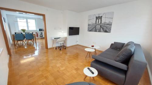 a living room with a couch and a table at FeelHome Ferienwohnung Tuttlingen in Tuttlingen
