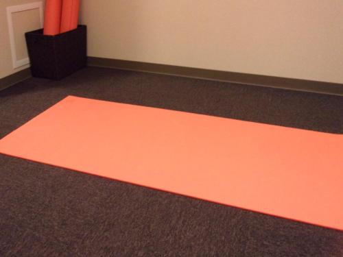 an orange rug on the floor in a room at Shinsaibashi ARTY Inn in Osaka