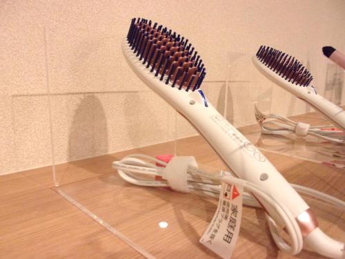 two toothbrushes sitting on top of a wooden table at Shinsaibashi ARTY Inn in Osaka