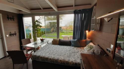 a living room with a bed and a table and a couch at House Kalmia in Fonyód