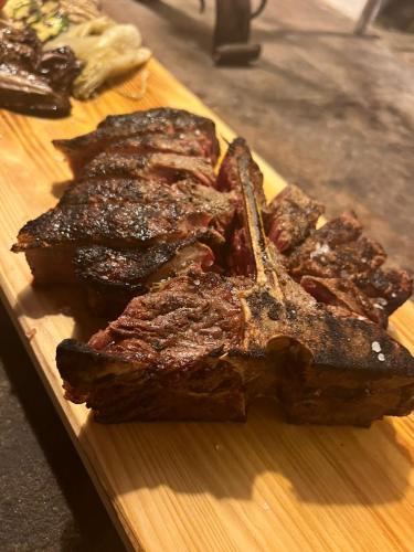 two pieces of meat on a wooden cutting board at LOCANDA PODERE LE VIGNE in Radda in Chianti