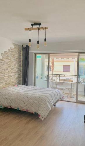 une chambre avec un lit et un mur de briques dans l'établissement Charmant studio juan les pins: 30 mètres de la mer, à Juan-les-Pins