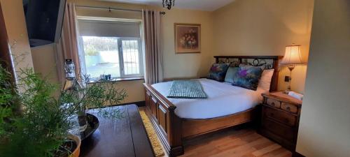 a bedroom with a bed and a window at Creevagh (Room Only) in Keel