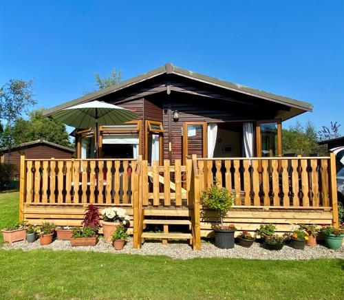 a wooden fence in front of a house with plants at Dot's Place 1 in Carnforth