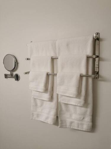 two towels hanging on a towel rack in a bathroom at LuxQuarters Kitimat River Suite in Kitimat