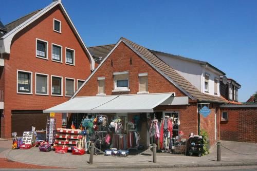 sklep przed ceglanym budynkiem w obiekcie Ferienwohnung Hafeneck w mieście Neuharlingersiel