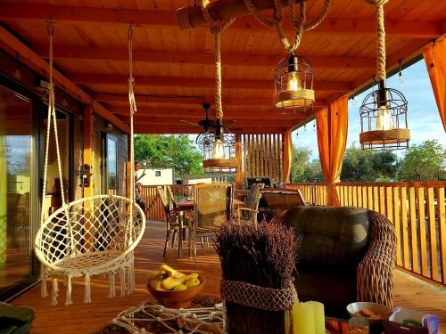 a screened in porch with chairs and a table at MiraMa MobileHome in Selce
