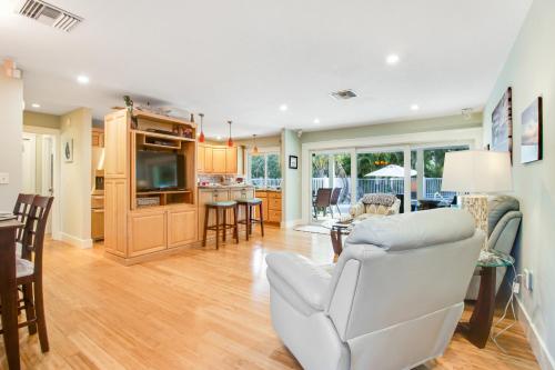 a living room with a white couch and a kitchen at Almost There in Bradenton