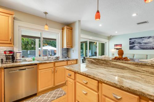 a large kitchen with wooden cabinets and a window at Almost There in Bradenton