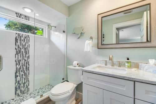 a bathroom with a toilet and a shower and a sink at Almost There in Bradenton