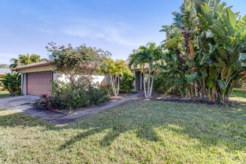 a house with palm trees and a garage at Almost There in Bradenton