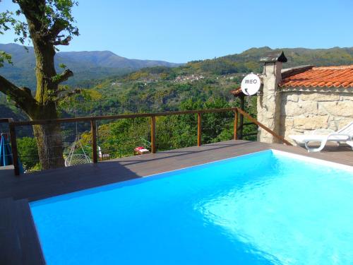 a swimming pool with a view of a mountain at Casa da Carvalheira in Parada