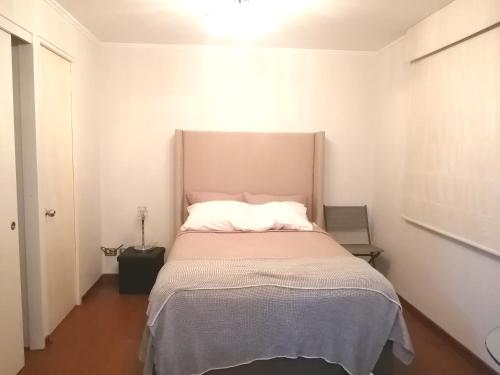 a bedroom with a bed with a large headboard at DEPARTAMENTO ESTUDIO FULL EQUIPADO WIFI CERCA A TODO LIMA in Lima