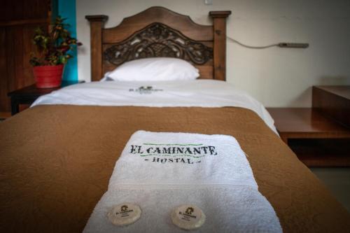 a bed with two towels on top of it at Hostal El Caminante in El Cocuy