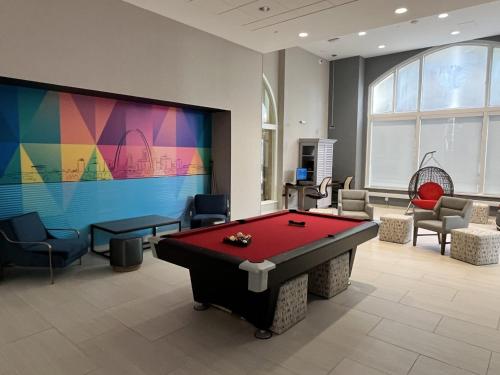 a room with a pool table and a large screen at Home2 Suites By Hilton St Louis Downtown in Saint Louis