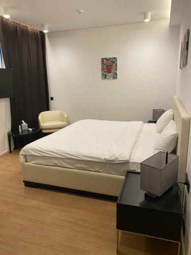 a bedroom with a bed and a table and a chair at Sea Breeze White Villas in Bilgah