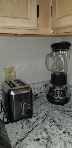 a blender and a toaster sitting on a counter at Cheerful 2-Bedroom, 2 bath with private parking in Fayetteville