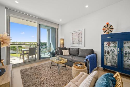 a living room with a couch and a table at Hamptons By The Beach - Moana - C21 SouthCoast Holidays in Moana