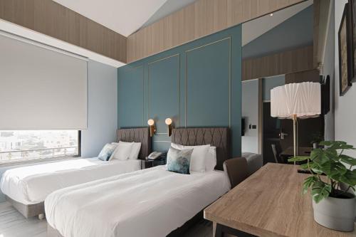 Postel nebo postele na pokoji v ubytování 森行旅 Mori Hotel -台南安平老街