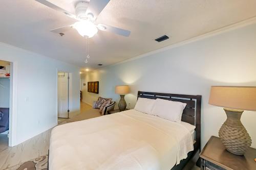 a bedroom with a bed and a ceiling fan at The Inn at St Thomas Square 1304A in Panama City Beach