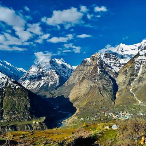 a view of a mountain range with snow covered mountains at Lahaul Home Stay Sumnam in Tāndi