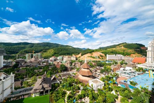 an aerial view of a city with mountains in the background at Mekong River Jing Land Hotel in Jinghong