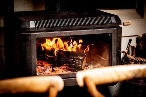a stove with a fire in the oven at Royal Hotel Mandurama in Mandurama
