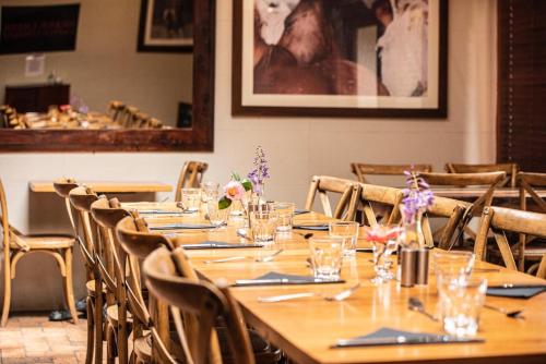 a dining room with a long table and chairs at Royal Hotel Mandurama in Mandurama