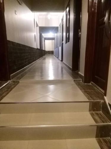 an empty hallway in a building with a long corridor at Stusky Lark Mini Hotel Seeta in Seeta