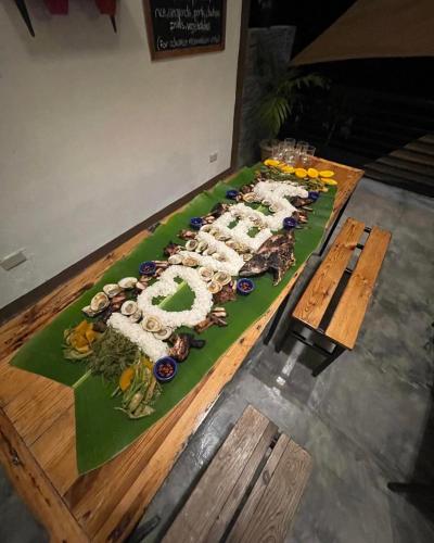 a long table with a buffet of food on it at Vela Terraces Hotel in Coron
