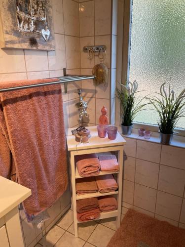 a bathroom with a sink and a shower with towels at Bed&Breakfast M&M in Kungsbacka