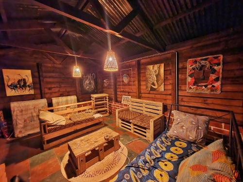
a room with a bed, a table, and a window at Mazzola Safari House & Backpacking in Arusha
