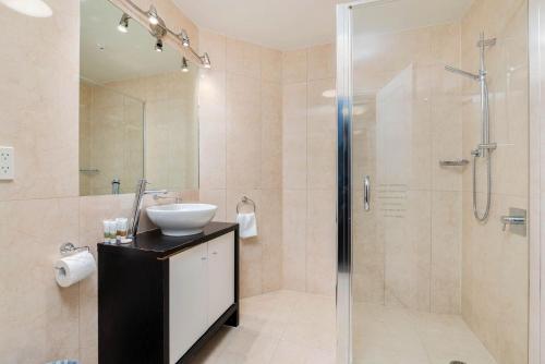a bathroom with a sink and a shower at Central Luxury at 407 The Beacon Studio in Queenstown