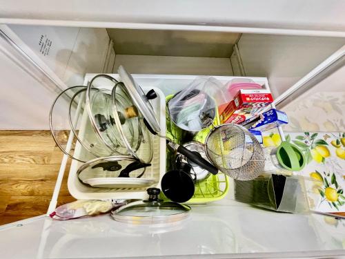 a drawer filled with dishes and other kitchen utensils at Kominka Okinawa in Okinawa City