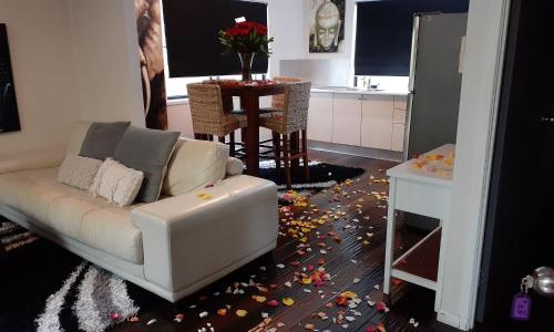 a living room with a couch and a table with debris on the floor at Alaya Ascend in Eudlo