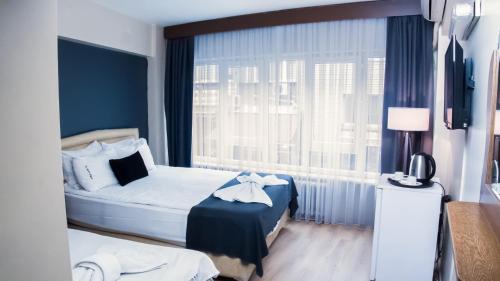 מיטה או מיטות בחדר ב-Hotel Cesmeli
