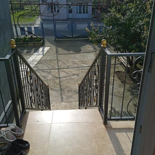 an open door to a patio with a gate at E L A in K'obulet'i