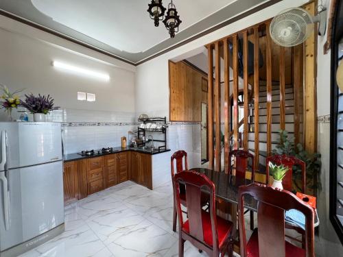 a kitchen with a table and a refrigerator at Homestay Phúc Lâm in Vạn Ninh