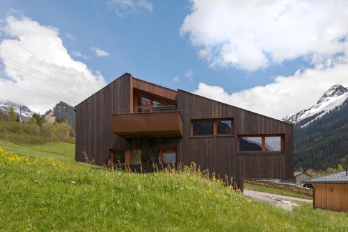 a wooden house on top of a hill at Apartment Hoamelig in Wald am Arlberg