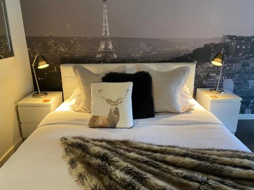 a bedroom with a white bed with a faux fur blanket at Paris Lorne in Lorne