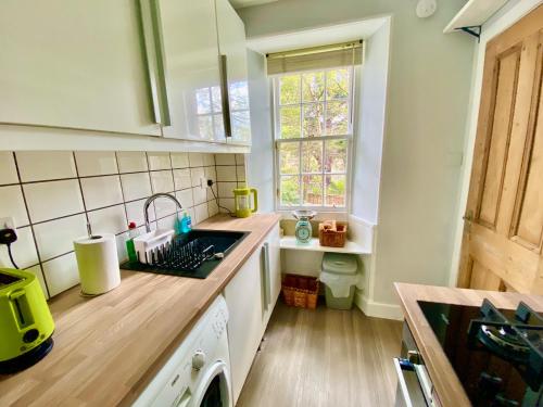 a kitchen with a sink and a counter top at Underneath the Arches in Penicuik