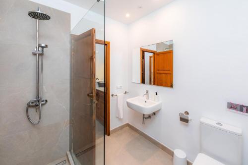 a bathroom with a shower and a sink at Can Big Charles in Pollença