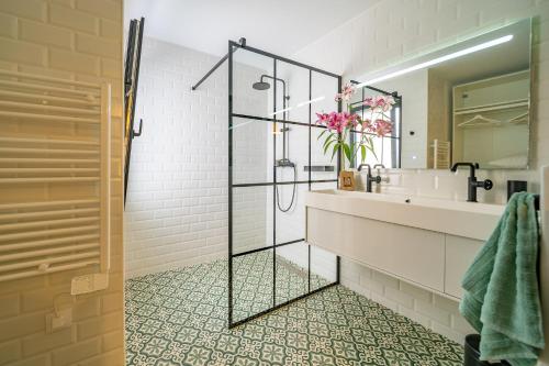 a bathroom with a shower and a sink at CAN MARTINEZ Calella Beach Boutique Apartment in Calella