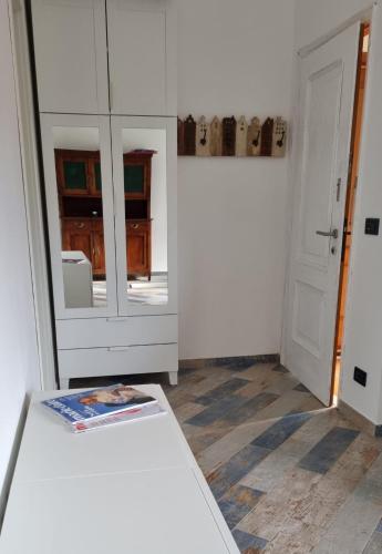 a room with a bed and a mirror and a door at LA CASETTA in Savona