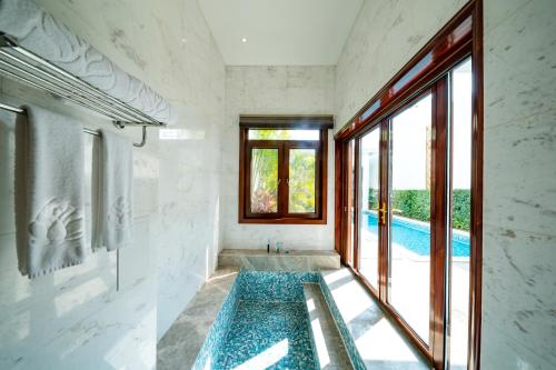 a bathroom with a swimming pool through a window at Mekong River Jing Land Hotel in Jinghong