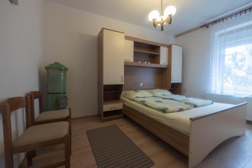 a bedroom with a bed and a chair in it at Apartment Gaja in Tolmin