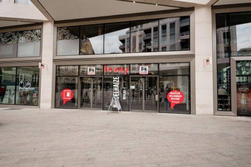 a store front of a building with revolving doors at Lux City Hamilius - Modern & Spacious Apart w/View in Luxembourg