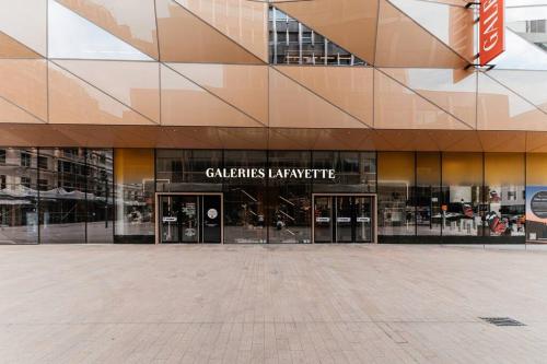 a large building with glass doors in a plaza at Lux City Hamilius - Modern & Spacious Apart w/View in Luxembourg