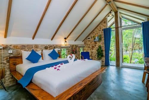 a bedroom with a large bed in a room at Green Valley Veal Pouch in Kampot