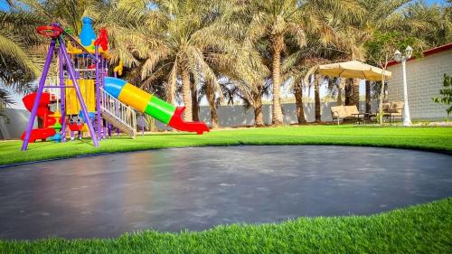 Children's play area sa Palm Escape Farmhouse - By Seven Elements